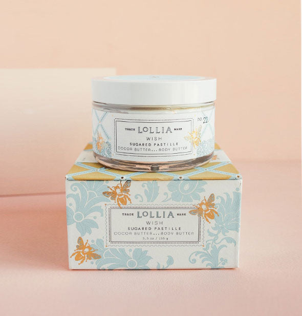 Jar and box of Lollia Wish Sugared Pastille Body Butter feature blue floral patterning accented with gold bees and lattice print on the box lid