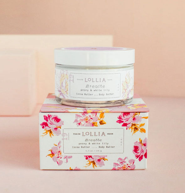 Jar and box of Lollia Breathe Body Butter with pink and gold floral patterning