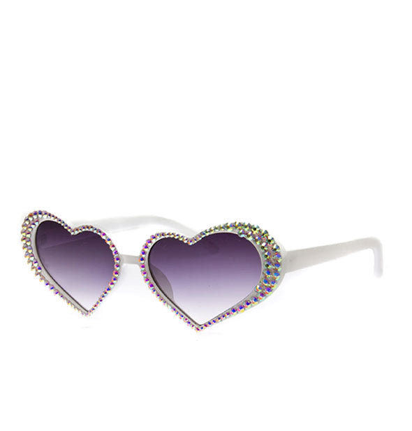 White heart-shaped sunglasses with rhinestones bordering grayish-blue gradient lenses