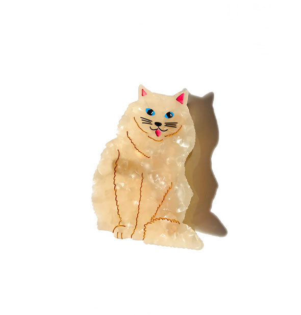 Cream-colored quartz-effect Persian cat hair clip is detailed with pink ears and tongue, blue eyes, black nose and whiskers, and gold line body details