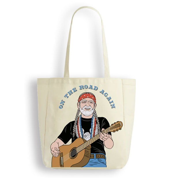 Canvas tote bag features illustration of smiling Willie Nelson wearing a red bandana and holding a guitar below the words, "On the road again" in blue lettering