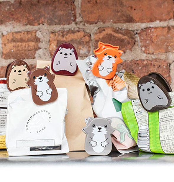 Woodland animal clips shown attached to the tops of snack bags against a brick backdrop