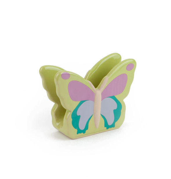 Green ceramic butterfly-shaped napkin holder features purple, blue, and turquoise painted wings
