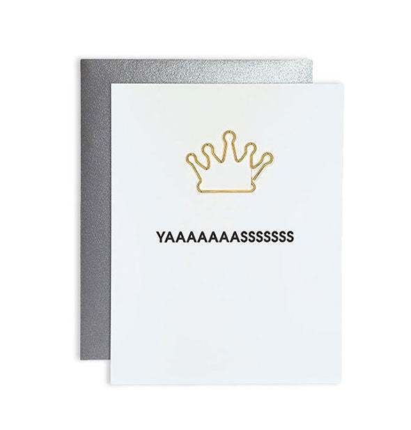 White greeting card with silver envelope behind and gold crown attached says, "Yaaaaaaasssssss" in black lettering