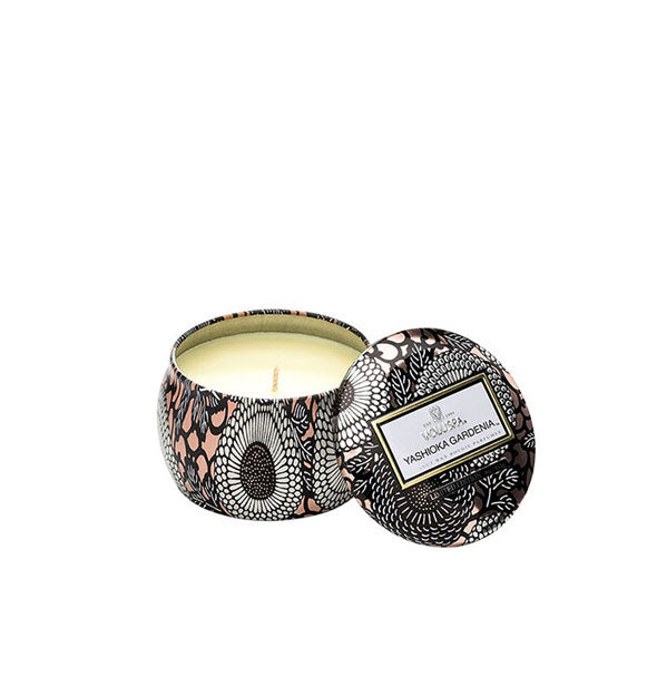 Small peach, white, and black floral Yashioka Gardenia Voluspa tin candle with lid removed