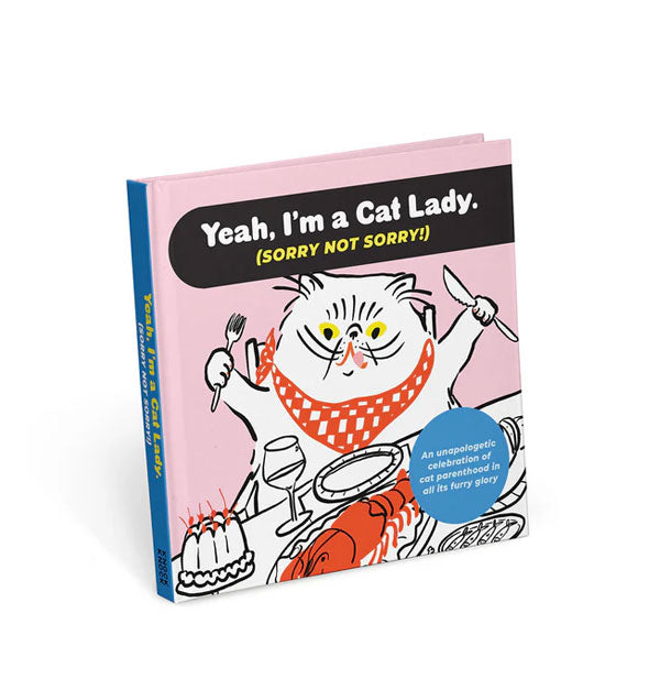Cover of Yeah, I'm a Cat Lady. (Sorry Not Sorry!) features illustration of a white cat seated at a dinner table with knife and fork in its paws and a red bib tied around its neck
