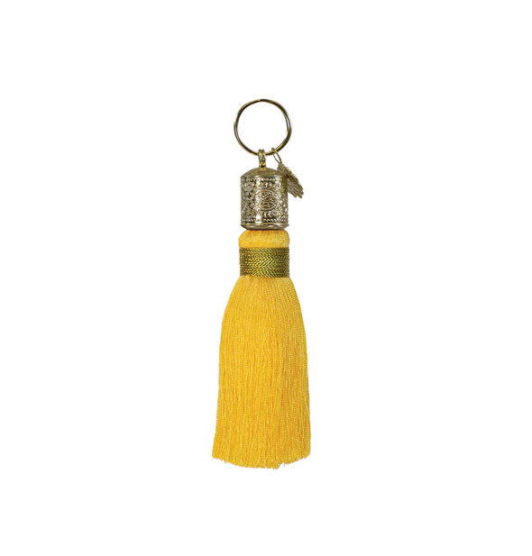 Yellow tassel keychain with decorative gold hardware