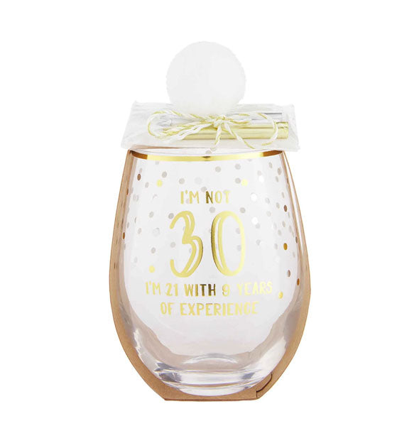 Stemless wine glass with gold rim, colorful confetti design, and white pom pom with birthday candle pack attached says, "I'm Not 30, I'm 21 With 9 Years of Experience" in gold foil lettering