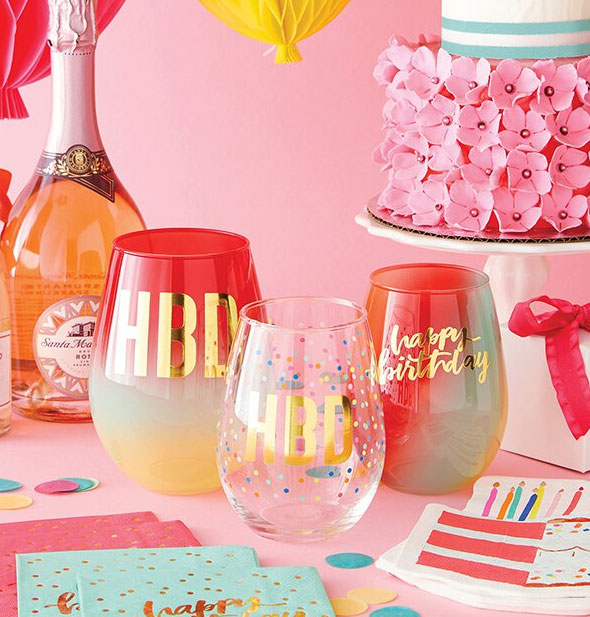 Festive birthday spread with wine glass assortment, rosé bottle, and decorative paper products