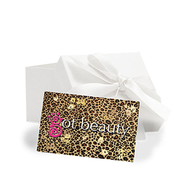 Leopard print gift card with Got Beauty logo rests against a white box with ribbon