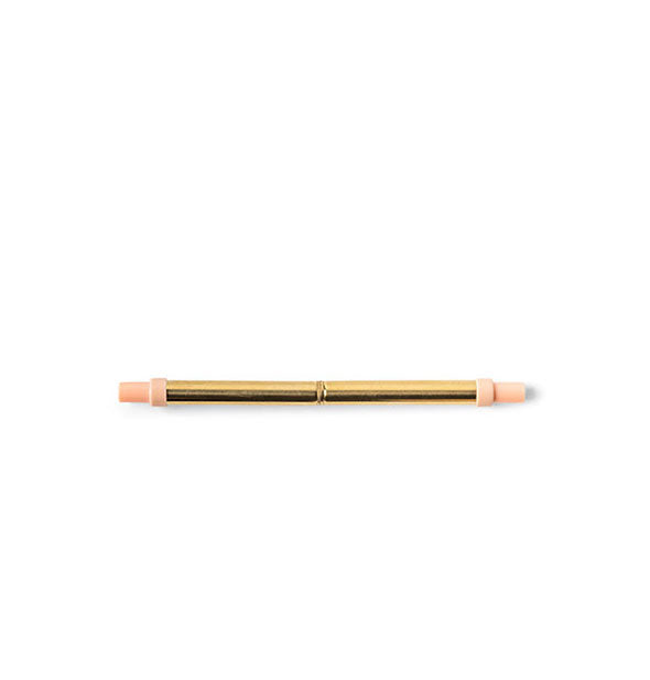 Collapsed stainless steel straw in gold tone with pink plastic ends