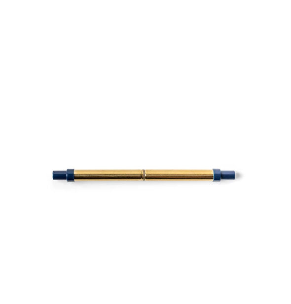 Collapsed stainless steel straw in gold tone with dark blue plastic ends