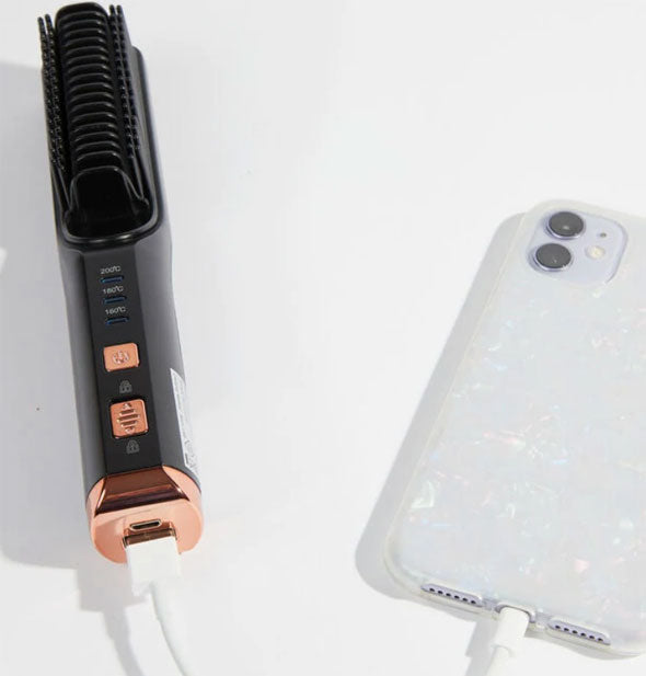 Hair straightening brush plugged into smart phone