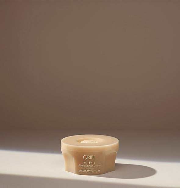 Pot of Oribe Air Style Flexible Finish Cream on neutral background