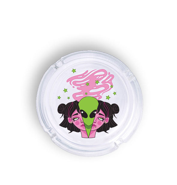 Round glass ashtray features illustration of a green alien emerging from a woman's pink halved face in a plume of pink smoke with green stars