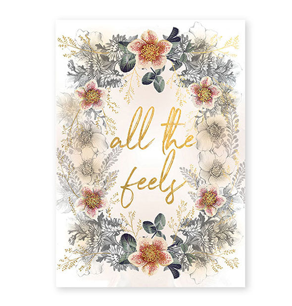 White greeting card with intricate floral design says, "All the feels" in metallic gold script lettering in the center
