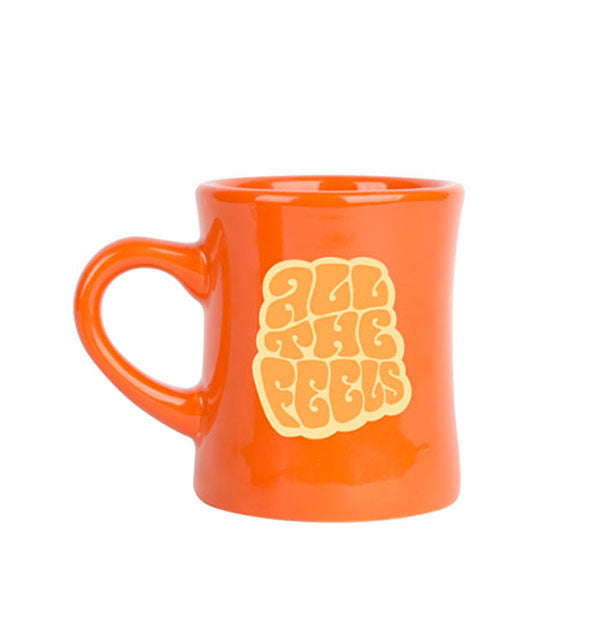 Orange diner coffee mug says, "All the feels" in yellow and orange retro-style lettering