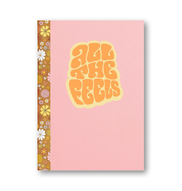 Pink notebook with brown floral binding says, "All the Feels" in retro-style typeface