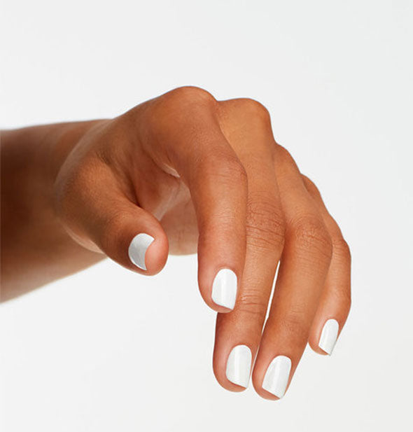 Model's hand wears a white shade of nail polish