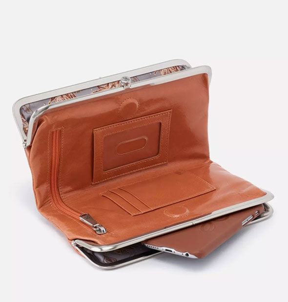 Brown leather wallet propped open to show interior storage compartments