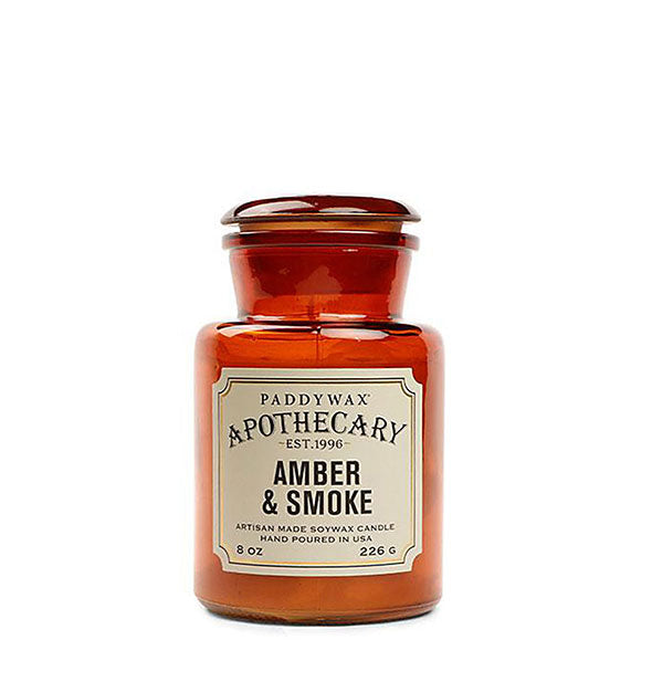 Amber 8-ounce glass apothecary-style candle jar with decorative off-white label.