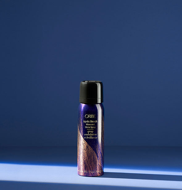 2.1 ounce can of Oribe Après Beach Wave and Shine Spray on a blue background