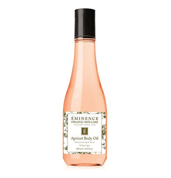 Peachy-coral 8.2 ounce bottle of Eminence Organic Skin Care Apricot Body Oil with white floral label and black cap
