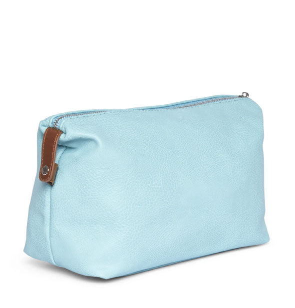 A textured vegan leather dopp cosmetic bag in a light blue/aquamarine color with brown zipper pull.