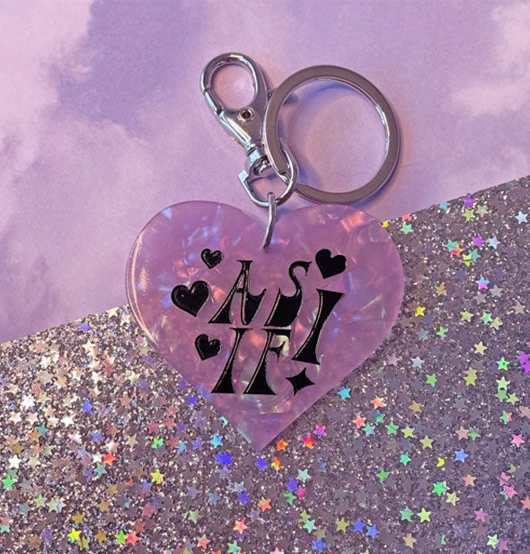 Purple mother of pearl-effect heart-shaped keychain says, "As if!" in black lettering with heart accents; silver hardware at top