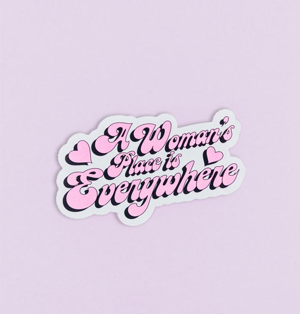 Sticker says, "A Woman's Place is Everywhere" in retro cursive pink font with heart accents