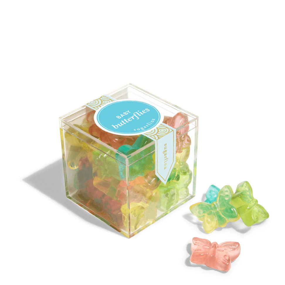 A small clear cube of Sugarfina Baby Butterflies gummy candies with several gummies displayed outside the packaging.