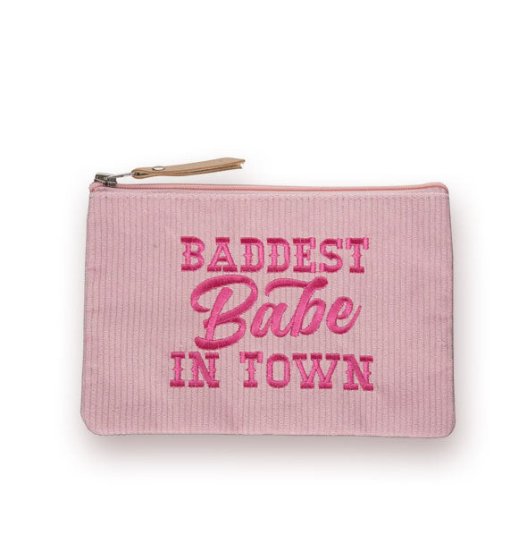 Rectangular pink corduroy pouch with brown zipper pull tab is embroidered with the words, "Baddest babe in town" in dark pink
