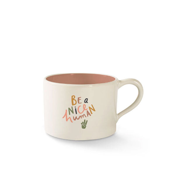 Stout cream-colored mug/teacup with dark blush interior says, "Be a nice human" in colorful lettering with a peace hand sign graphic