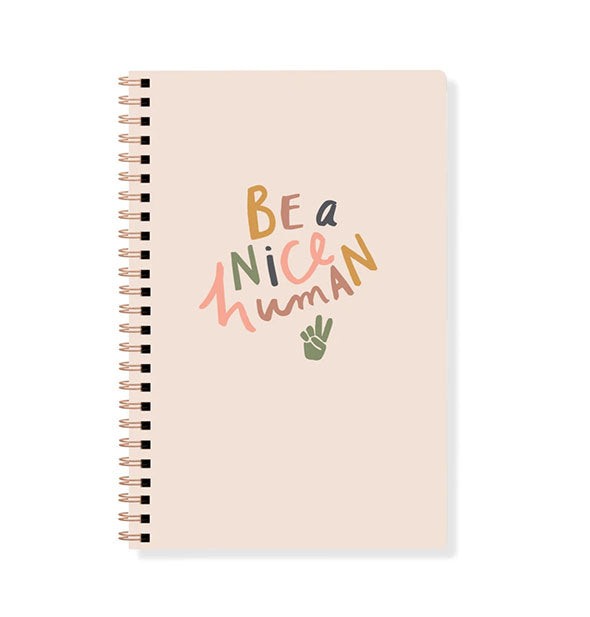 Light pink journal cover with spiral binding and colorful lettering that says, "Be a Nice Human" with peace hand symbol graphic
