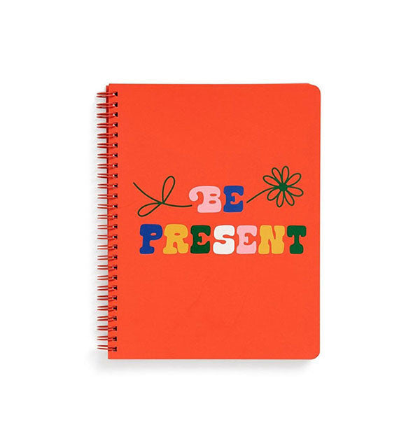 Orange spiral-bound notebook cover says, "Be Present" in multicolor lettering with flower graphic