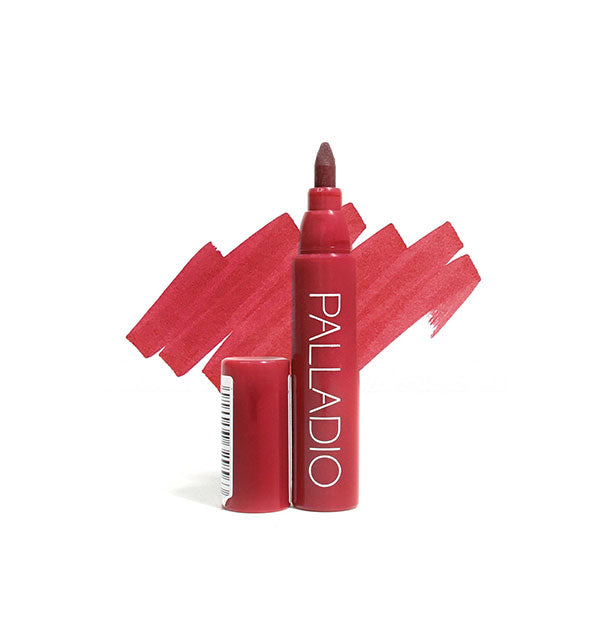 Berry red Palladio lip stain pen with cap removed and sample color swatch drawn behind