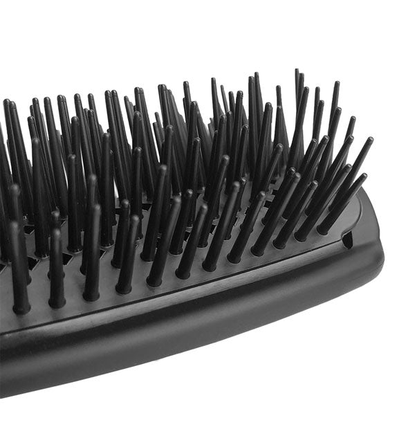 Closeup of the bristles on Cricket's Binge Compact Cushion Styler hairbrush shows staggered lengths
