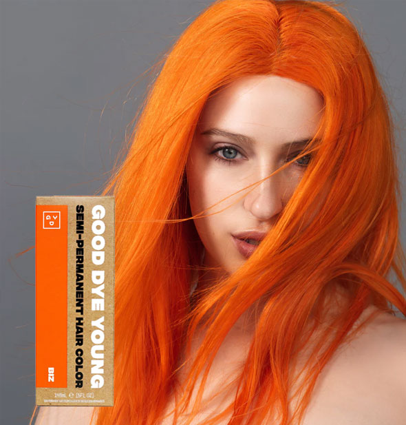 Model with bright orange hair color by Good Dye Young in the shade Biz