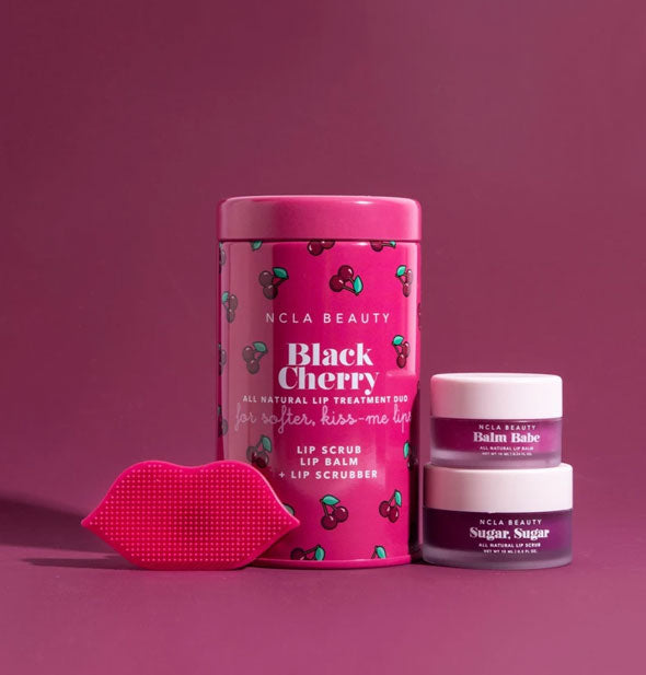 NCLA Beauty Black Cherry Lip Care Duo tin with contents shown: two jars of product and one magenta lip-shaped scrubber