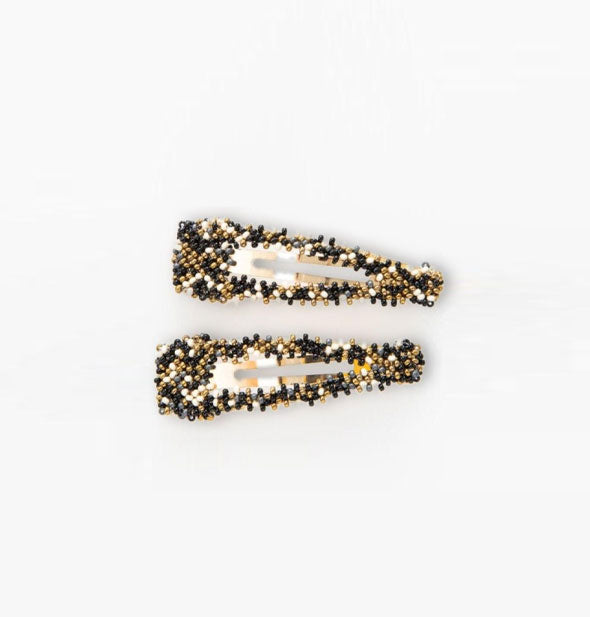 Pair of white, black and gold beaded snap-style hair clips