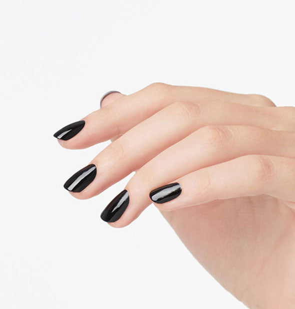 Model's hand wears a black shade of nail polish