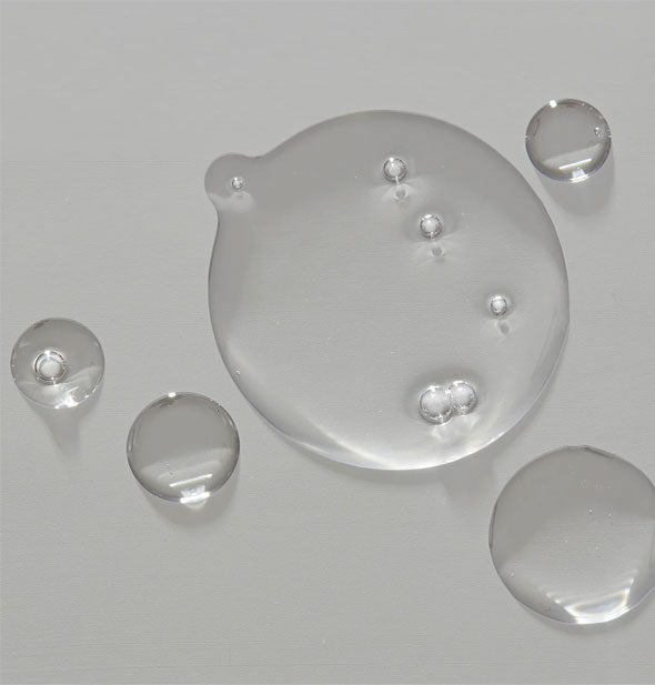 Clear droplets of Unite Blonda Oil with some bubbles