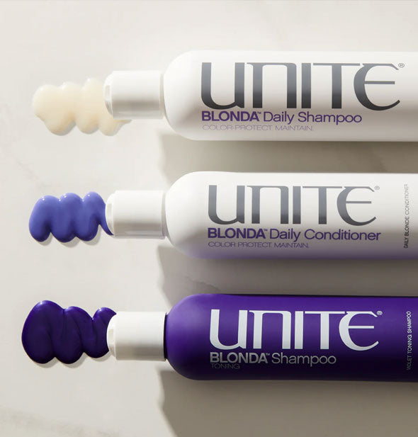 From top to bottom, bottles of Unite Blonda Shampoo, Blonda Daily Conditioner, and Blonda Daily Shampoo with sample product squiggles dispensed at left