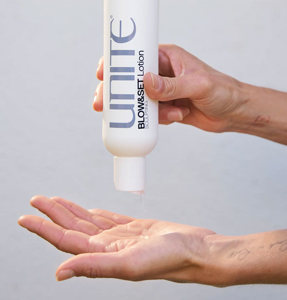 Model dispenses Unite BLOW&SEET Lotion into palm of hand