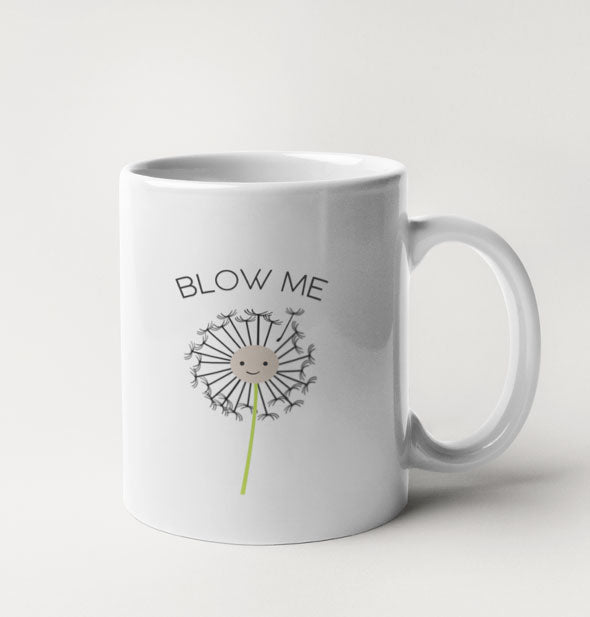 White coffee mug features a smiling dandelion illustration with the words, "Blow Me"