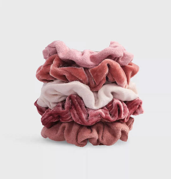 Stack of five hair scrunchies in blush toned velvet fabrics