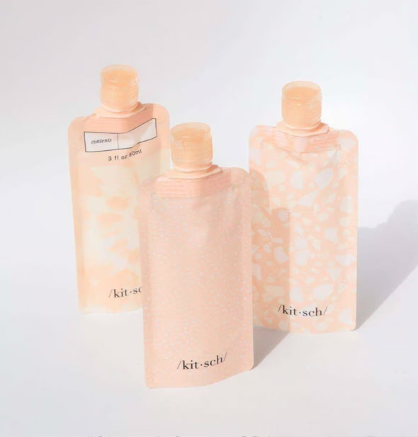 Three pink Refillable Travel Pouches by Kitsch