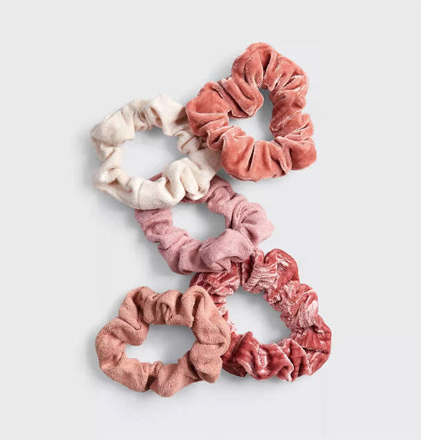 Five hair scrunchies in blush toned velvet fabrics
