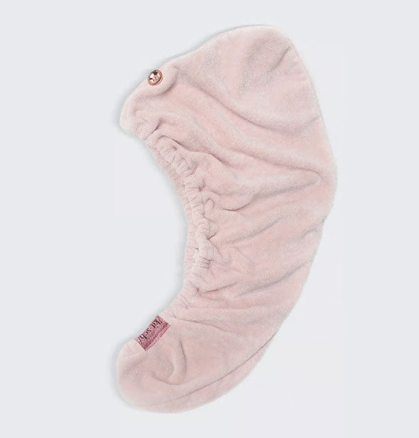 Blush microfiber hair towel wrap by Kitsch lays flat to show button closure and elastic opening