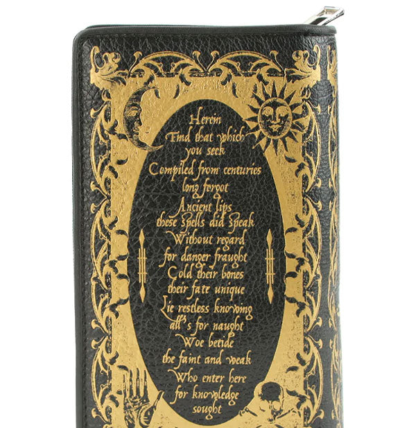 Closeup of black vinyl Book of Spells wallet reverse side shows metallic gold celestial symbols surrounding a spellcasting poem